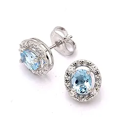 Ovaaleja korvarenkaat 9 karaatin valkokultaa kanssa zirkoni ja topaasia
